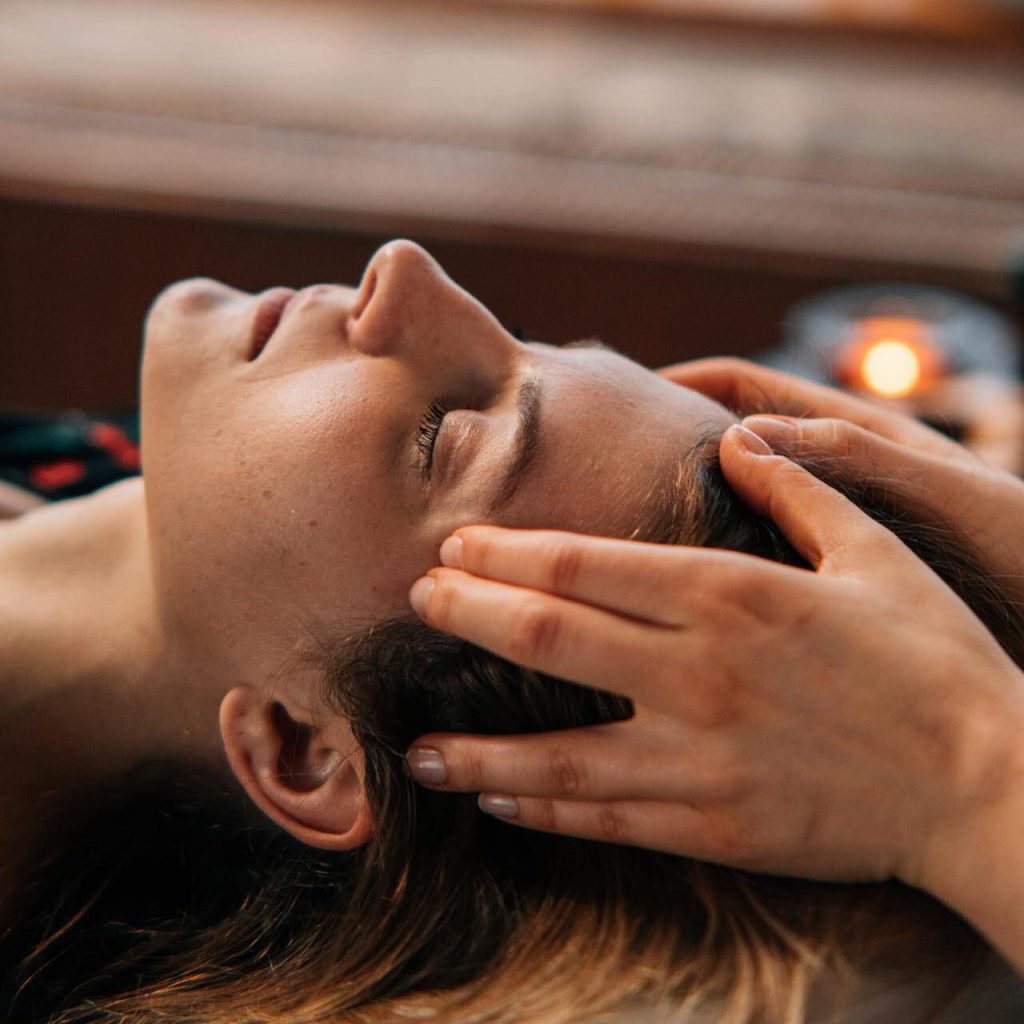 Woman receiving a head massage